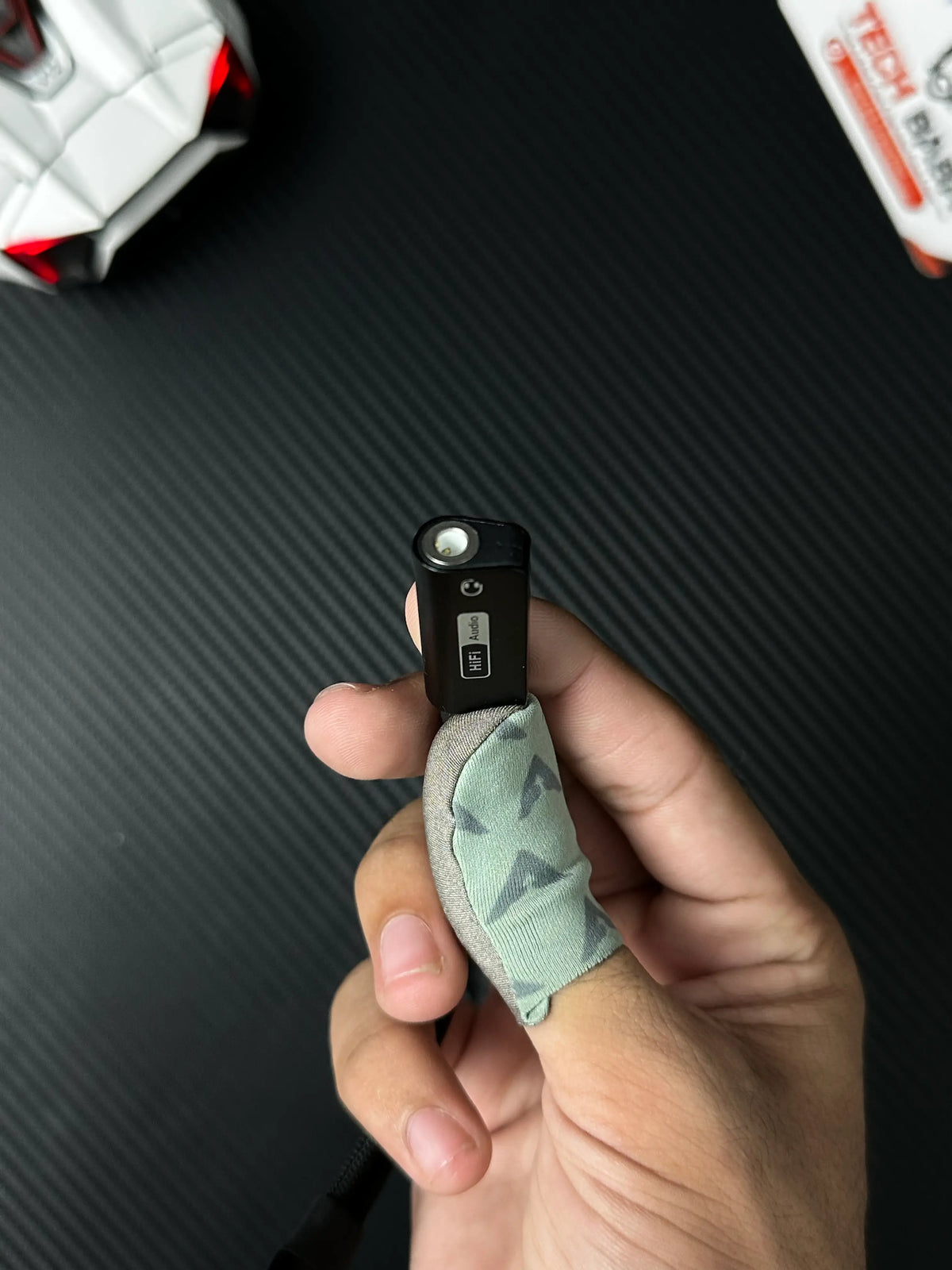 A hand holding UGREEN 25837 USB-C to 3.5mm Audio Adapter Pakistan which has showing 3.5mm audio jack .picture by TechBabaStore.pk
