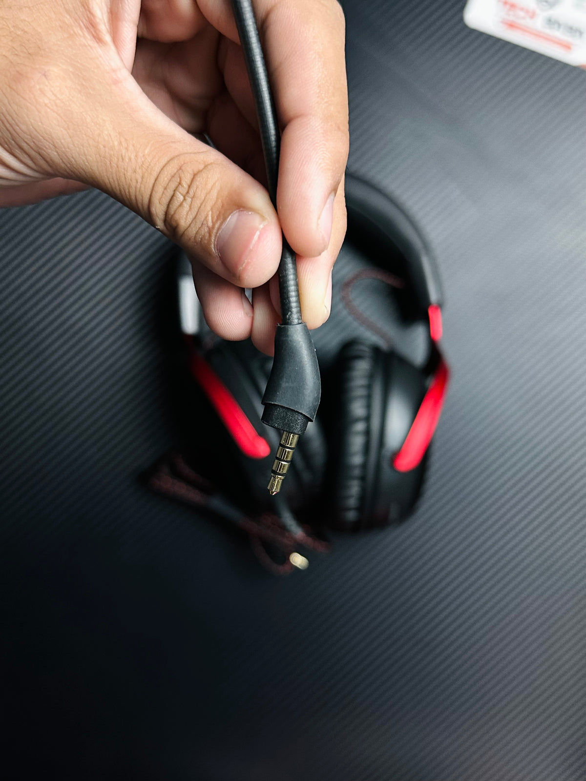 A  hand holding HyperX Cloud III Gaming Headset for PUBG Mobile  which has showing 3.5mm mic.picture by TechBabaStore.pk