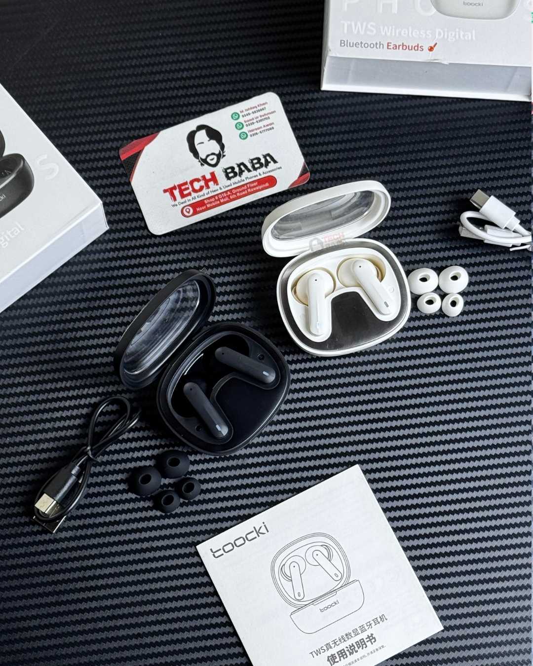 Toocki HE-068A Gaming Earbuds in White & Black Colour with their box components. Which are extra ear tips & a matching colour charging cable.