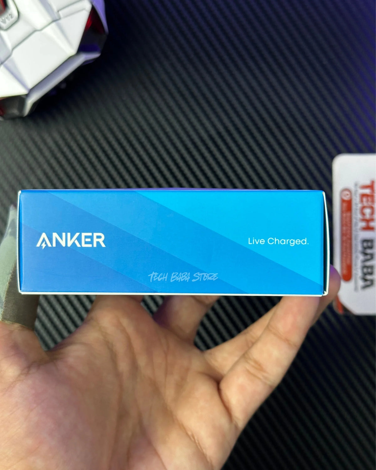 a hand hlding a box of  Anker Zolo 30W Compact USB-C GaN Charger and showing the Anker label. picture by techbabastore.pk