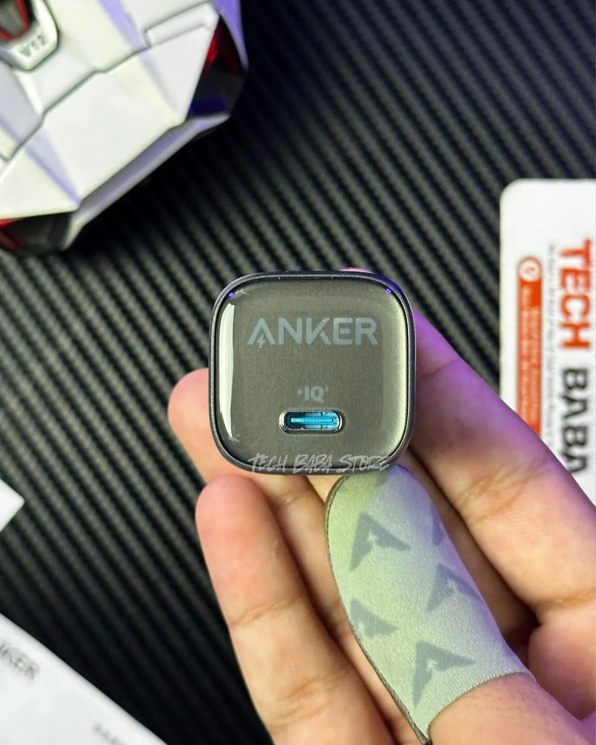 a hand holding a  Anker Zolo 30W Compact USB-C GaN Charger and showing closeup view. picture by techbabastore.pk