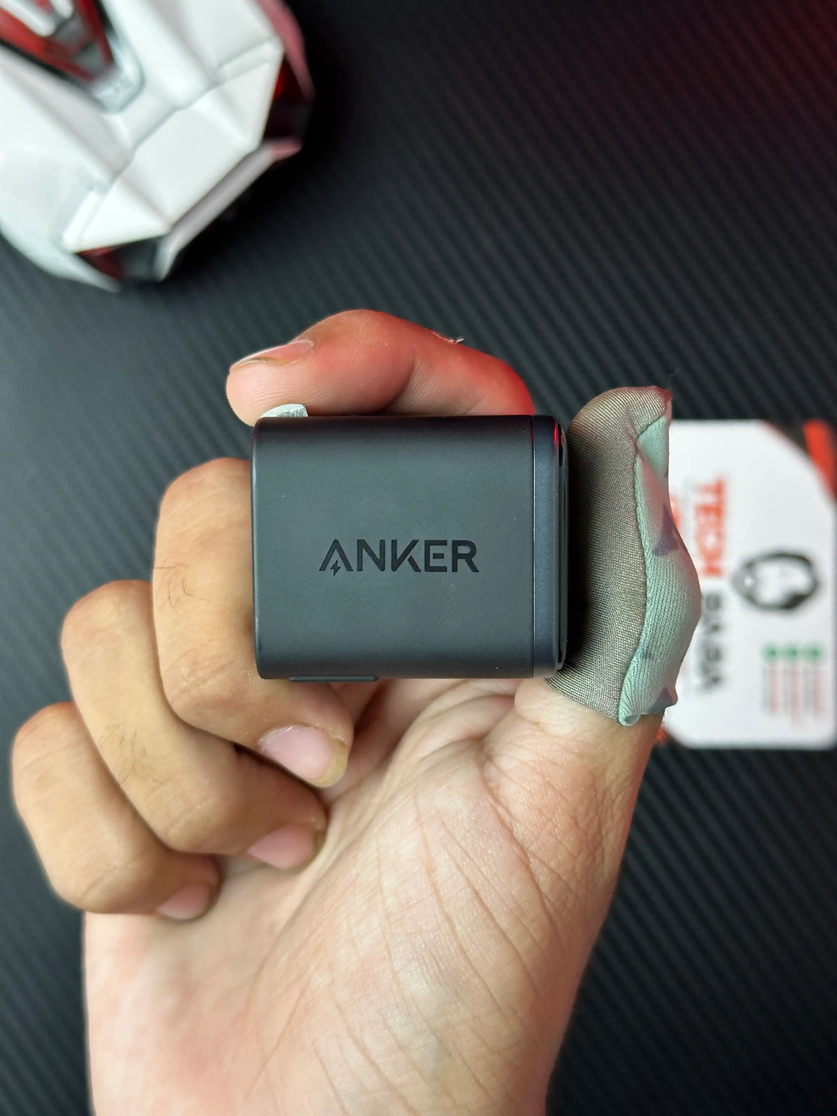 A hand holding nker_Nano_45W_Charger_With_Smart_Display which has showing anker logo.picture by TechBabaStore.pk
