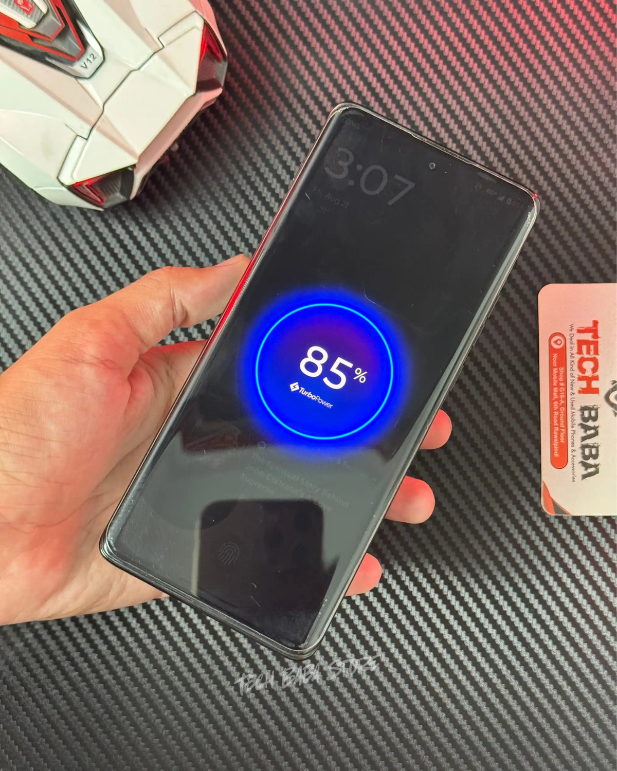 a hand holding a motorola Android phone whichb is wirelessly charging withBaseus PPCXM10 Wireless PowerBank and also showing motorola turbo power charging message. picture by TechBabaStore.pk
