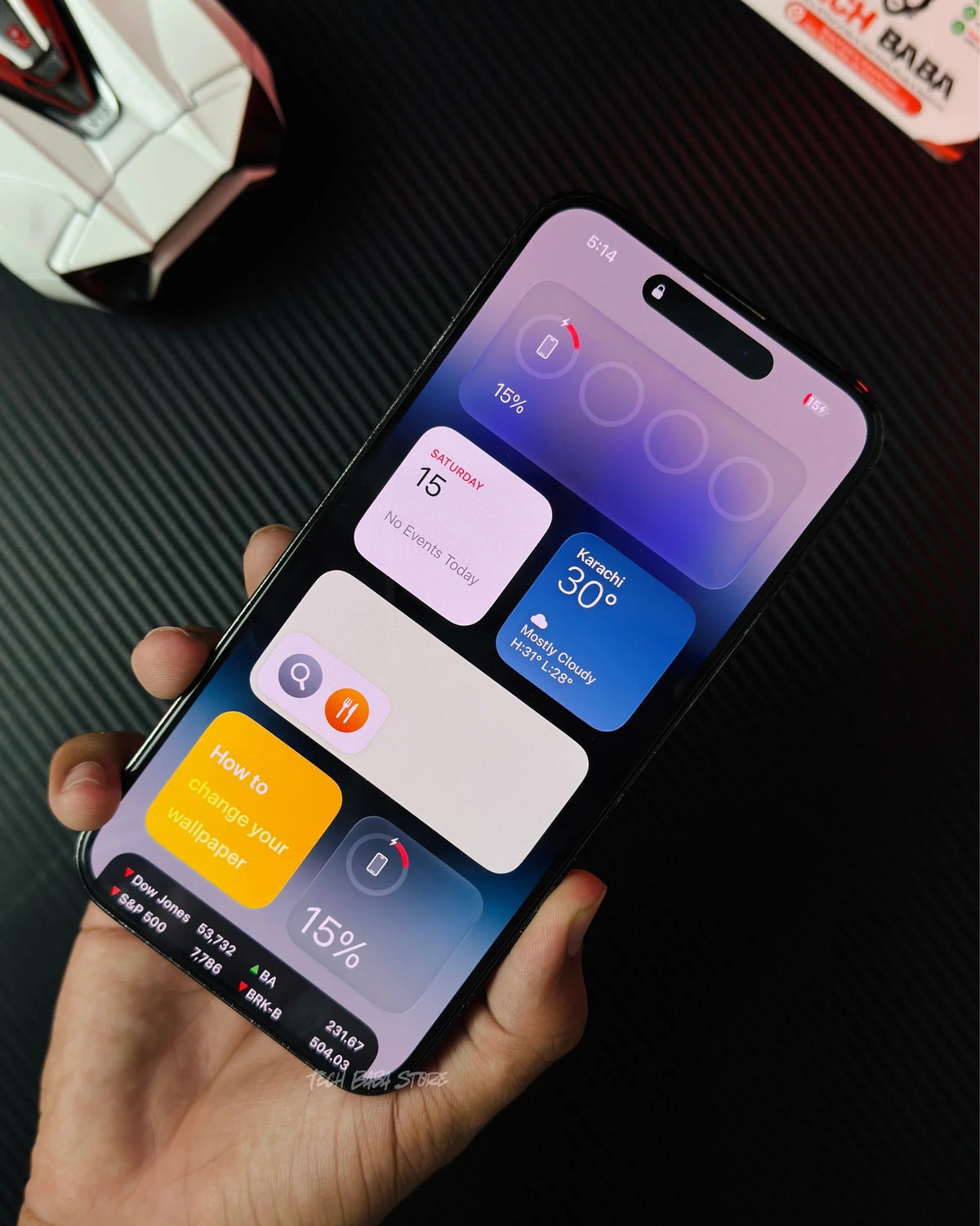a hand holding iphone which is wirelessly charging with Baseus PPCXM10 Wireless PowerBank. picture by TechBabaStore.pk