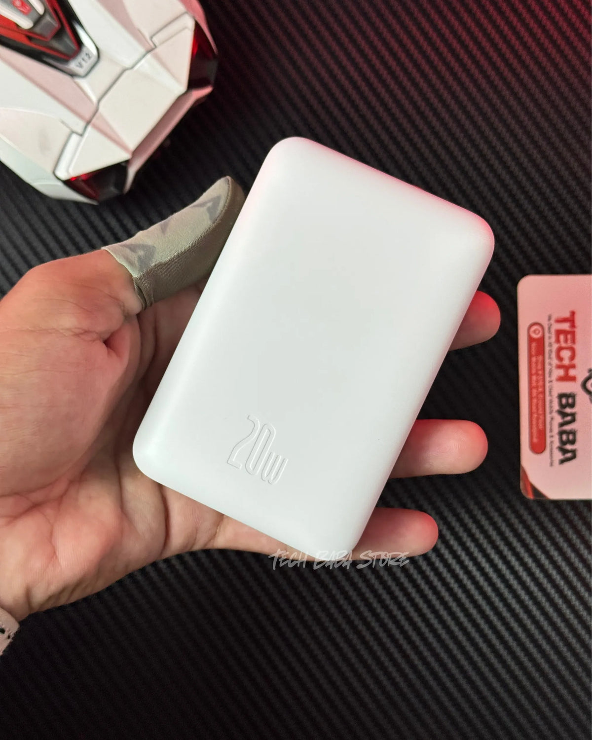 a hand holding a Baseus PPCXM10 Wireless PowerBank which is showing back closeup view.picture by TechBabaStore.pk