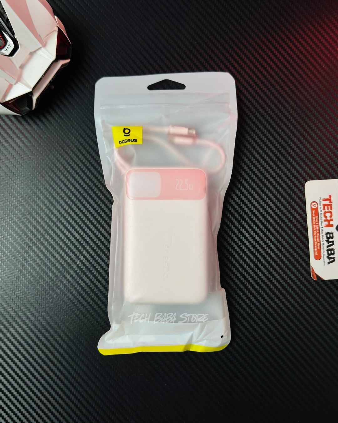 A handi holding a Pink colour Baseus Enerfill FC11 20000mAh 22.5W Power Bank that comes in packing. Picture by Techbabastore.pk