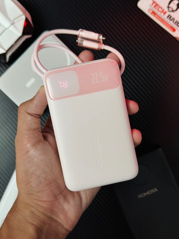 A handi holding a Pink colour Baseus Enerfill FC11 20000mAh 22.5W Power Bank that comes in packing. Picture by Techbabastore.pk