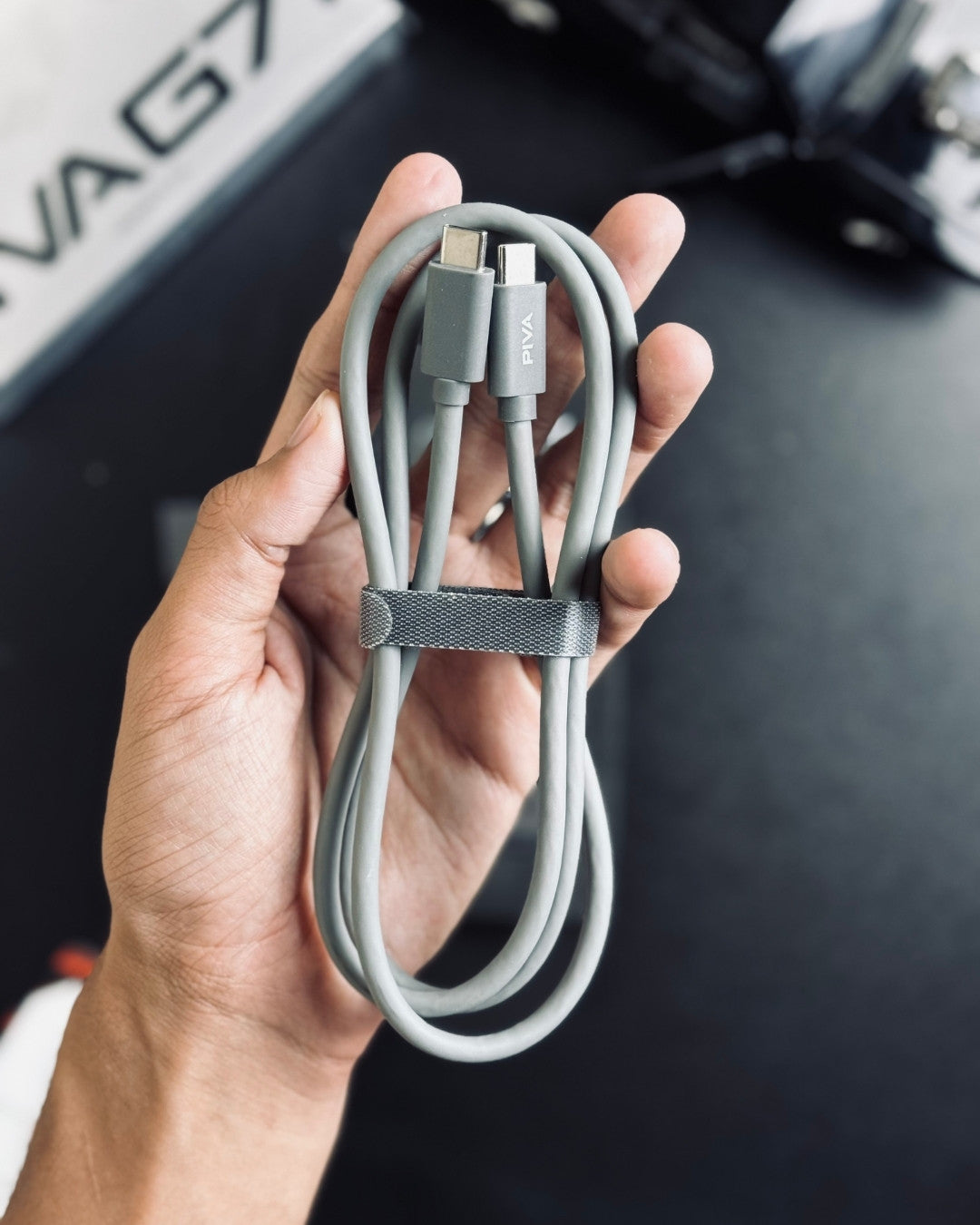 a hand holding Cable of PIVA_G71_7-in-1_Gaming_Splitter_Docking_Station
picture by Techbabastore.pk