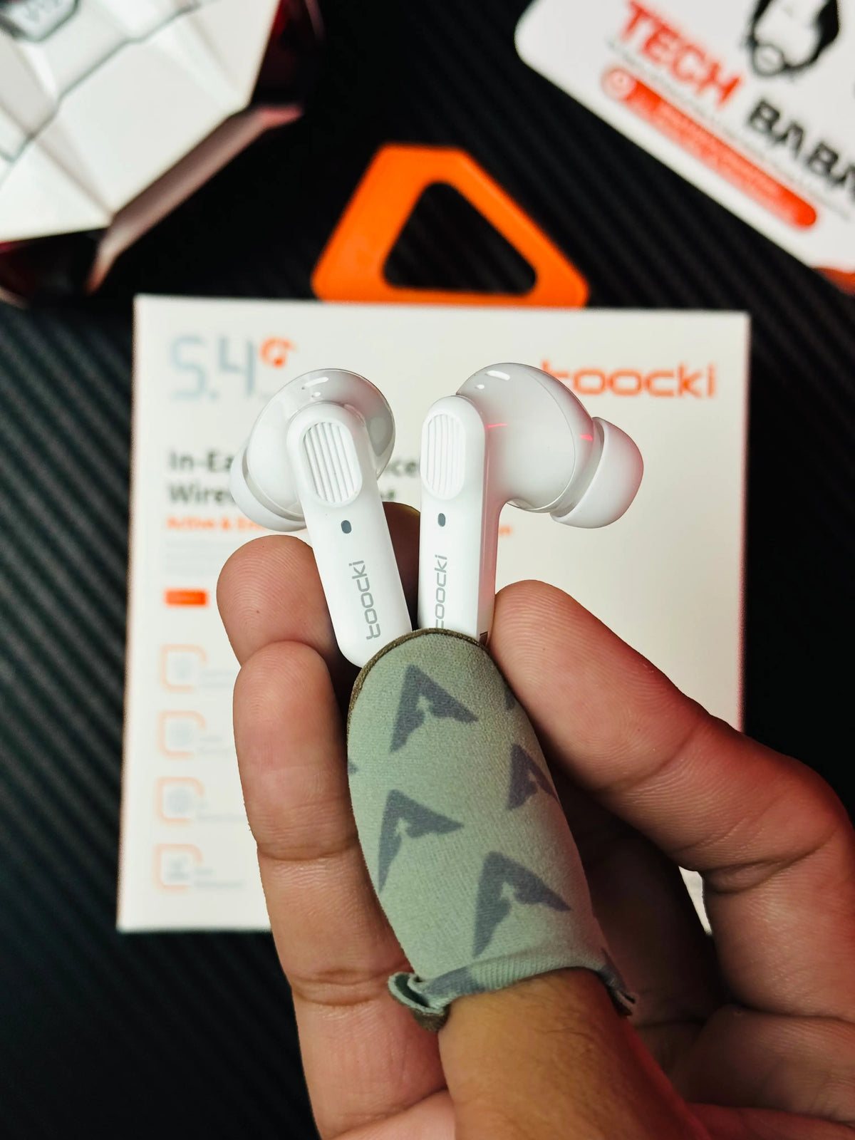 A hand holding Tocki Zero Delay Gaming Earbuds earbuds_picture by TechBabaStore.pk