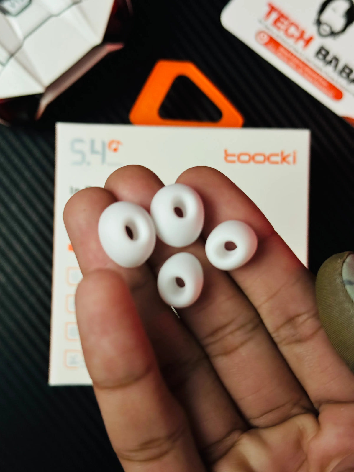 A hand holding Tocki Zero Delay Gaming Earbuds eartips_picture by TechBabaStore.pk