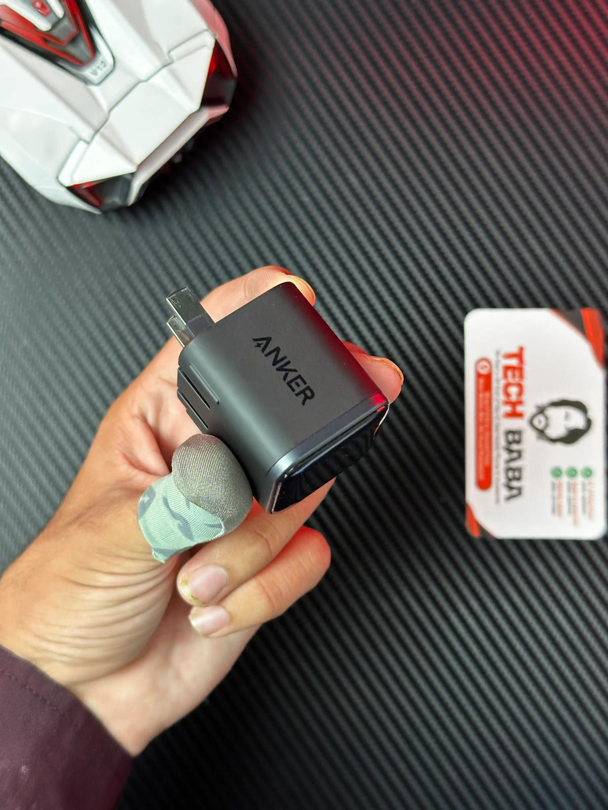 A hand holding nker_Nano_45W_Charger_With_Smart_Display which has showing hand on look.picture by TechBabaStore.pk
