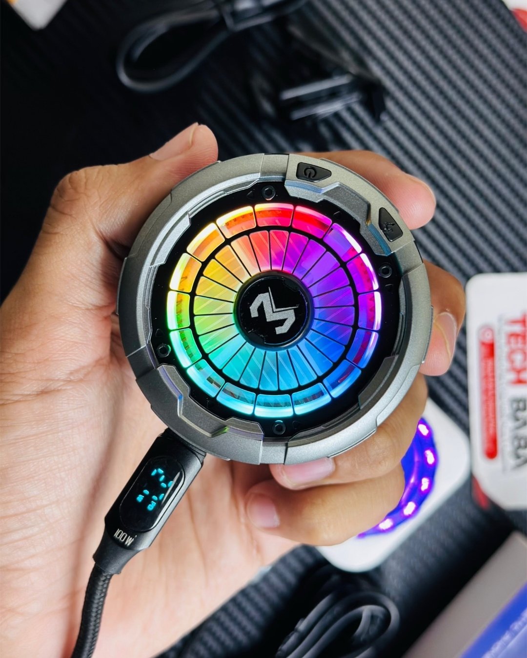 a hand holding a MEMO_CX26_Ultra_30W_Phone_Cooler Aand showing a lightning mode picture by techbabastore.pk