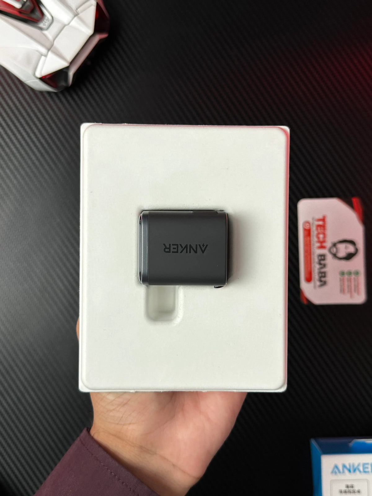 A hand holding open nker_Nano_45W_Charger_With_Smart_Display which has showing anker lable.picture by TechBabaStore.pk