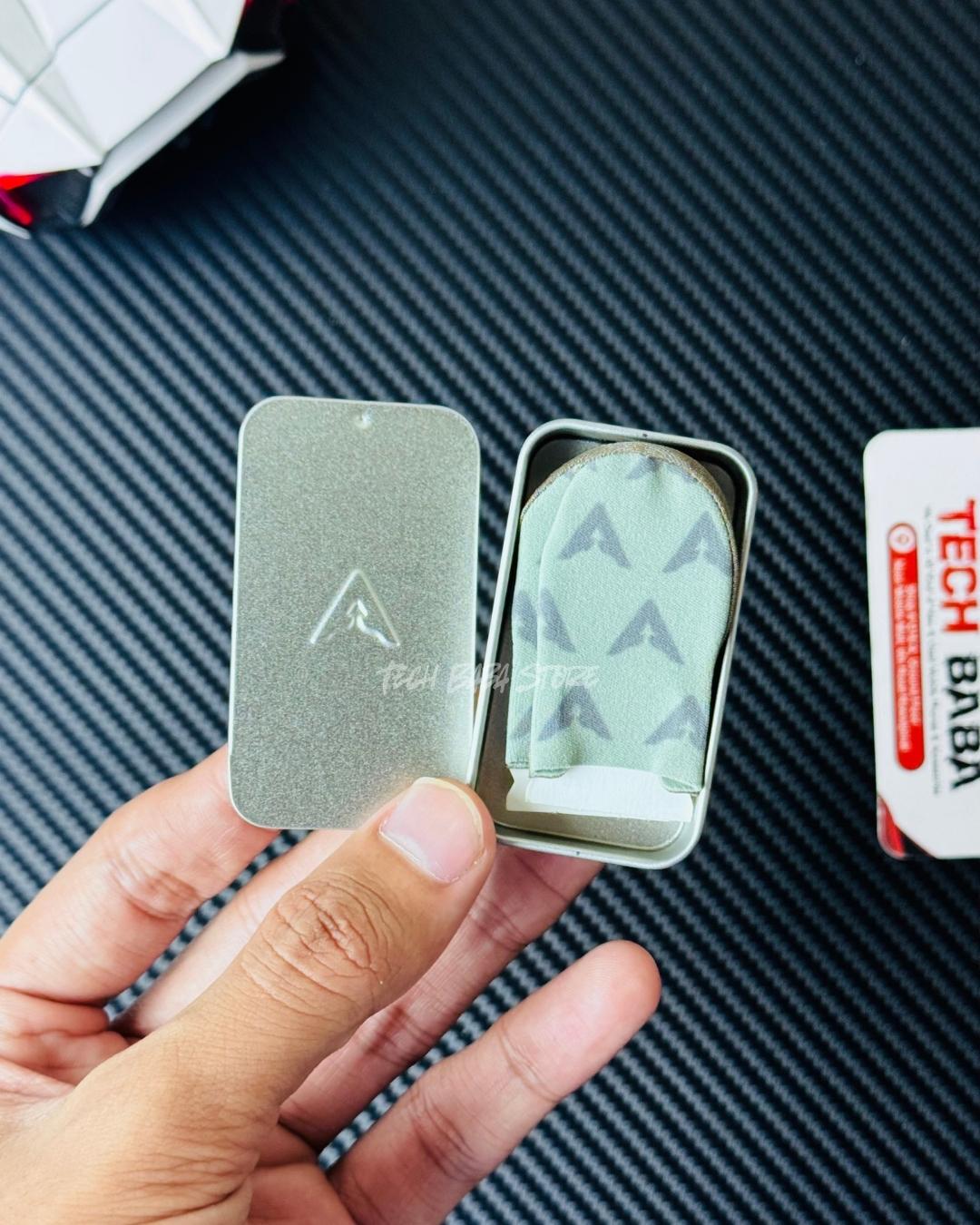 A hand holding opened Piva DragonScale 2 thumb Sleeves Metalic box that comes with the thumbs. Picture by TechBabaStore.pk