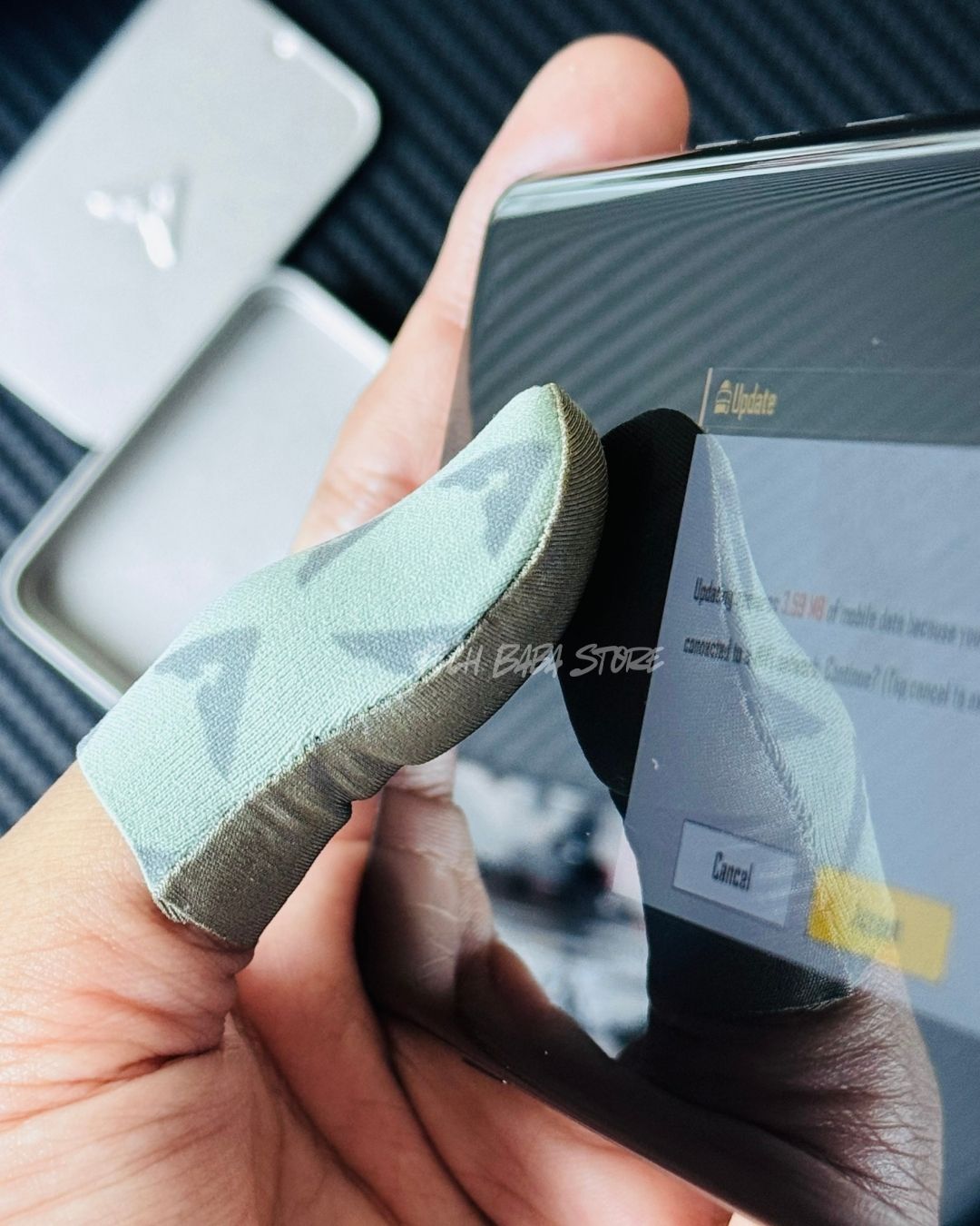 Showing a Piva DragonScale 2 ThumbSleeve wearing in a thumb using on Gaming Mobile Screen. Picture by TechBabaStore.pk