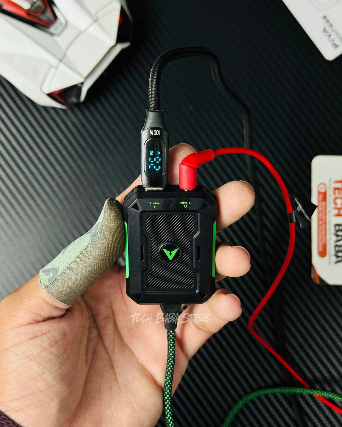  hand holding a Piva Gs2 Type C Splitter connected with charger and a 3.5mm headphones connected in the 3.5mm port and both ports are working simultaneously. Picture by TechBabaStore.pk