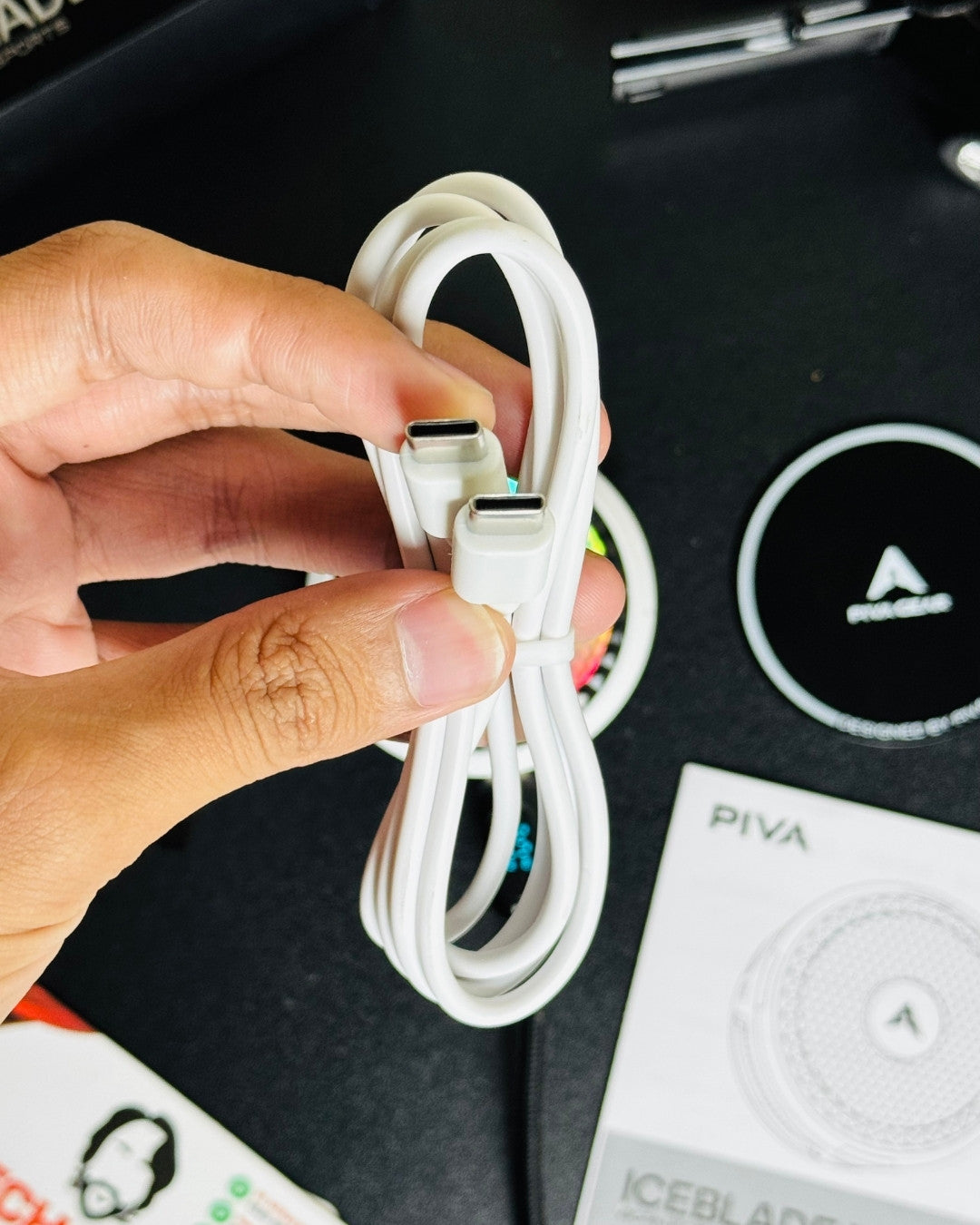 a hand holding a charging cable and also showing a closeup view of charging cable port. picture by techbabastore.pk