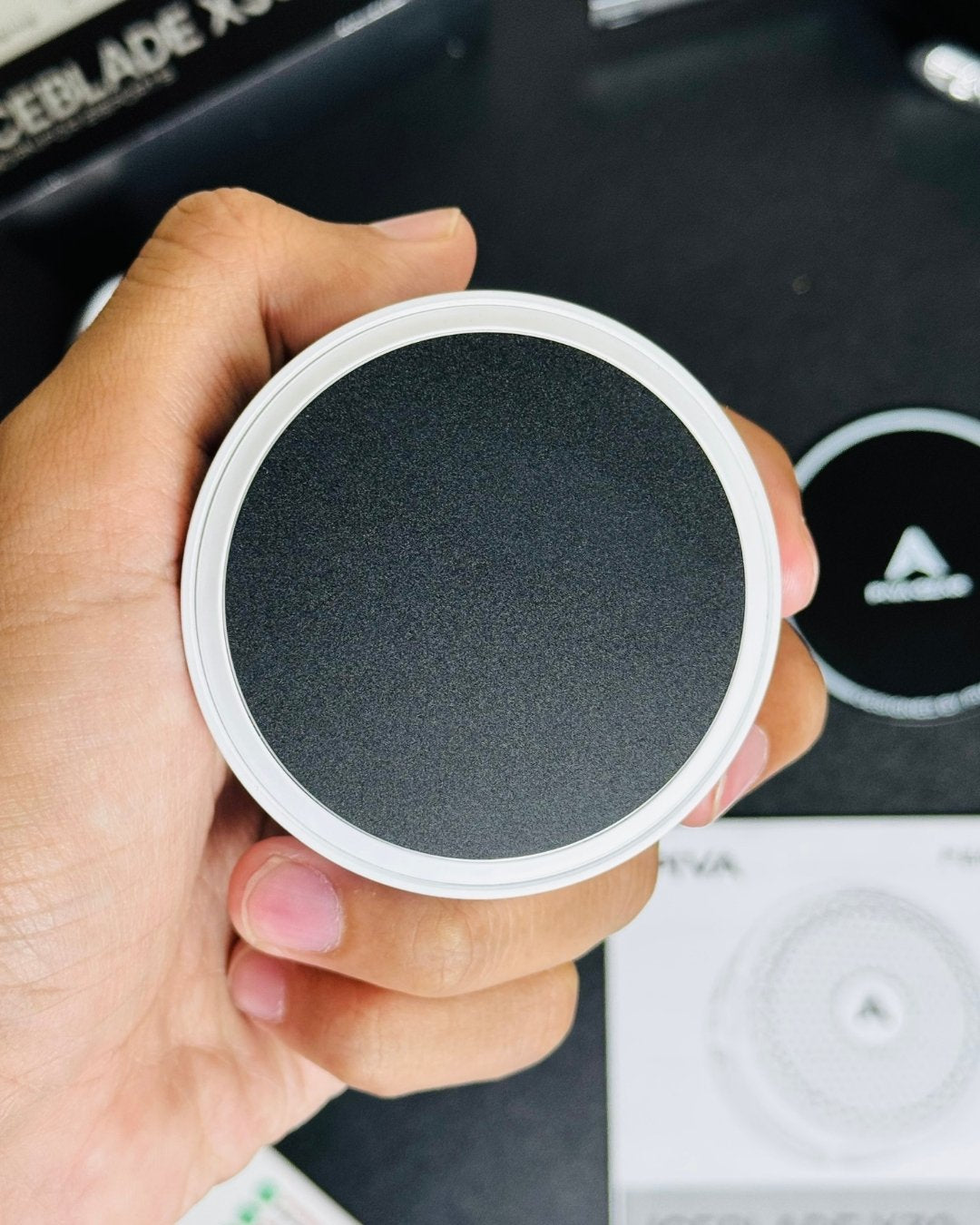 a hand holding a Piva_X30_Mobile_Cooling_Fan and showing a close up view of back side colling plate. picture by techbabastore.pk