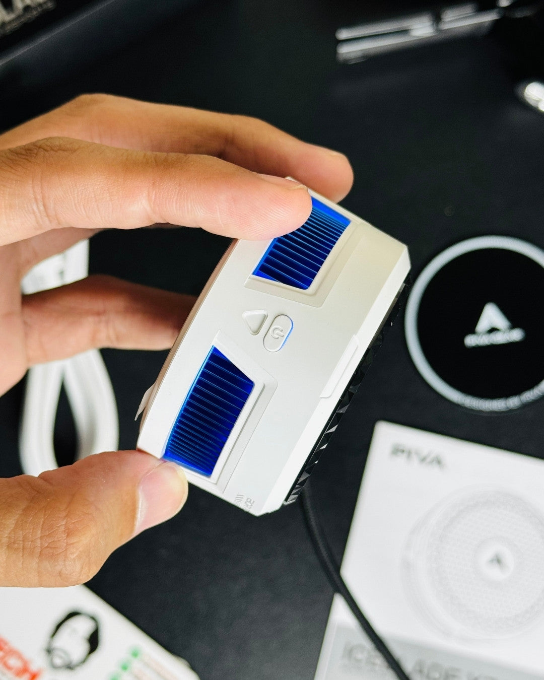 a hand holding a Piva X30 Mobile Cooling Fan and showing closeup view of power button. picture by techbabastore.pk