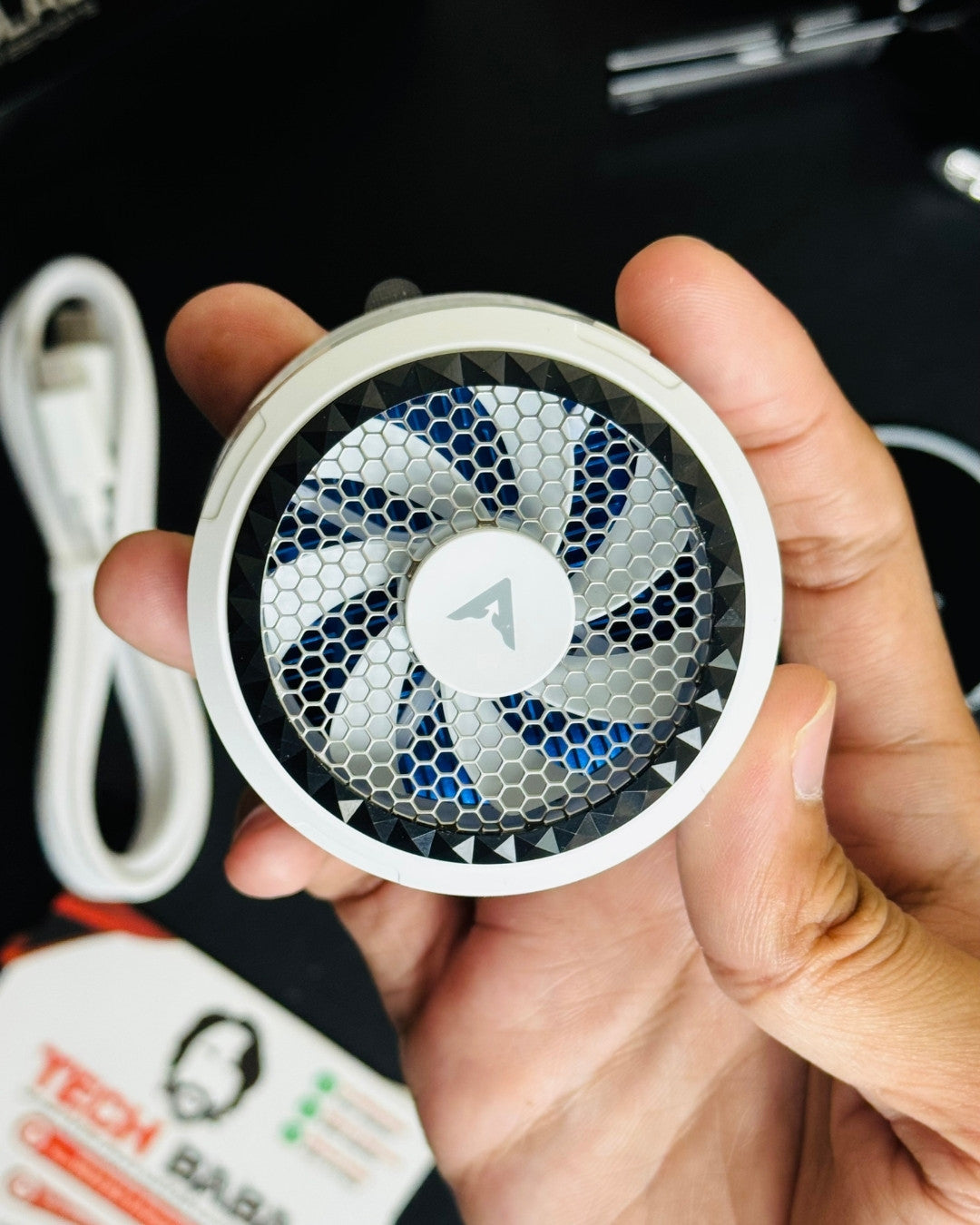Hand holding Piva X30 Cooling Fan and showing closeup view. picture by TechBabaStore.pk