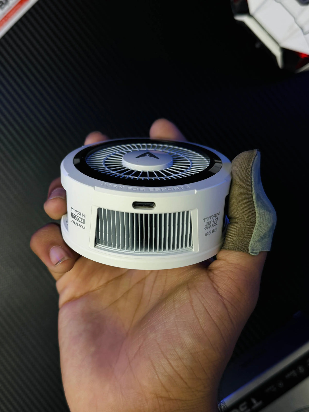 A hand holding Piva Titan T300 iPad Cooler — 45W Semiconductor Cooling Fan for PUBG Mobile which has showing Ctype port .picture by TechBabastore.pk
