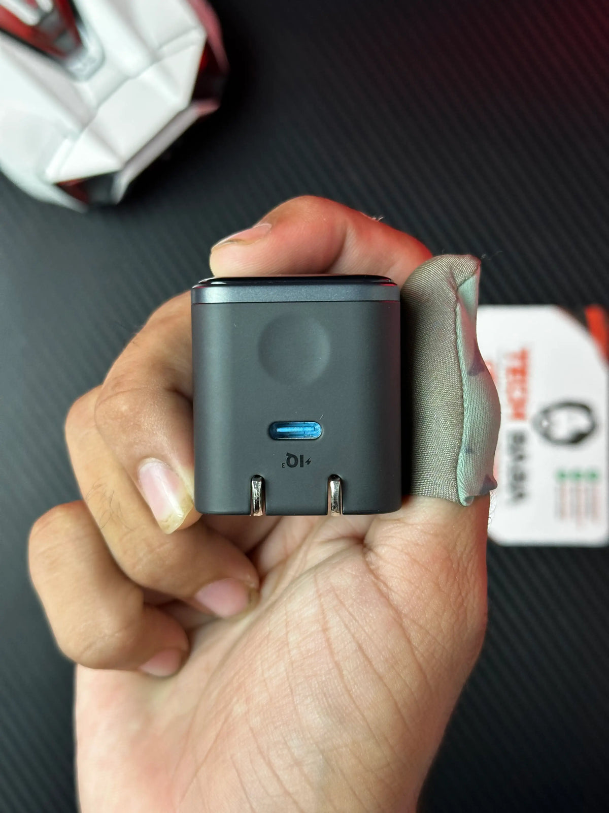 A hand holding nker_Nano_45W_Charger_With_Smart_Display which has showing type c port.picture by TechBabaStore.pk