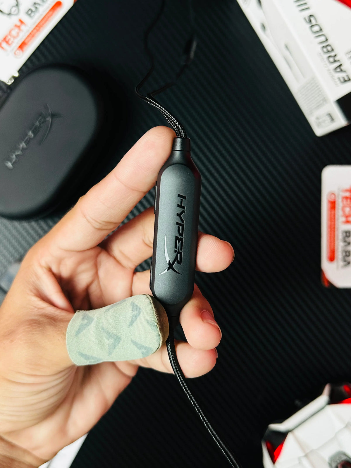 A haind holdin microophonme of HyperX Cloud Earbuds III S USB-C Gaming Earbuds -picture by TEchBabaStore.pk