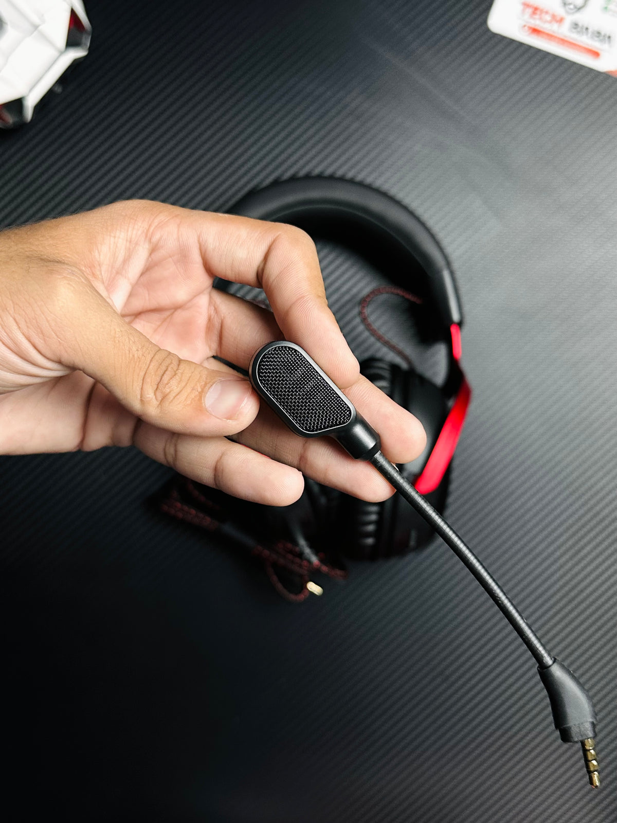 A hand holding HyperX Cloud III Gaming Headset for PUBG Mobile — Zero-Delay Wired Audio, 53mm Drivers, Detachable Mic which has showing detachable mic.picture by TechBabaStore.pk