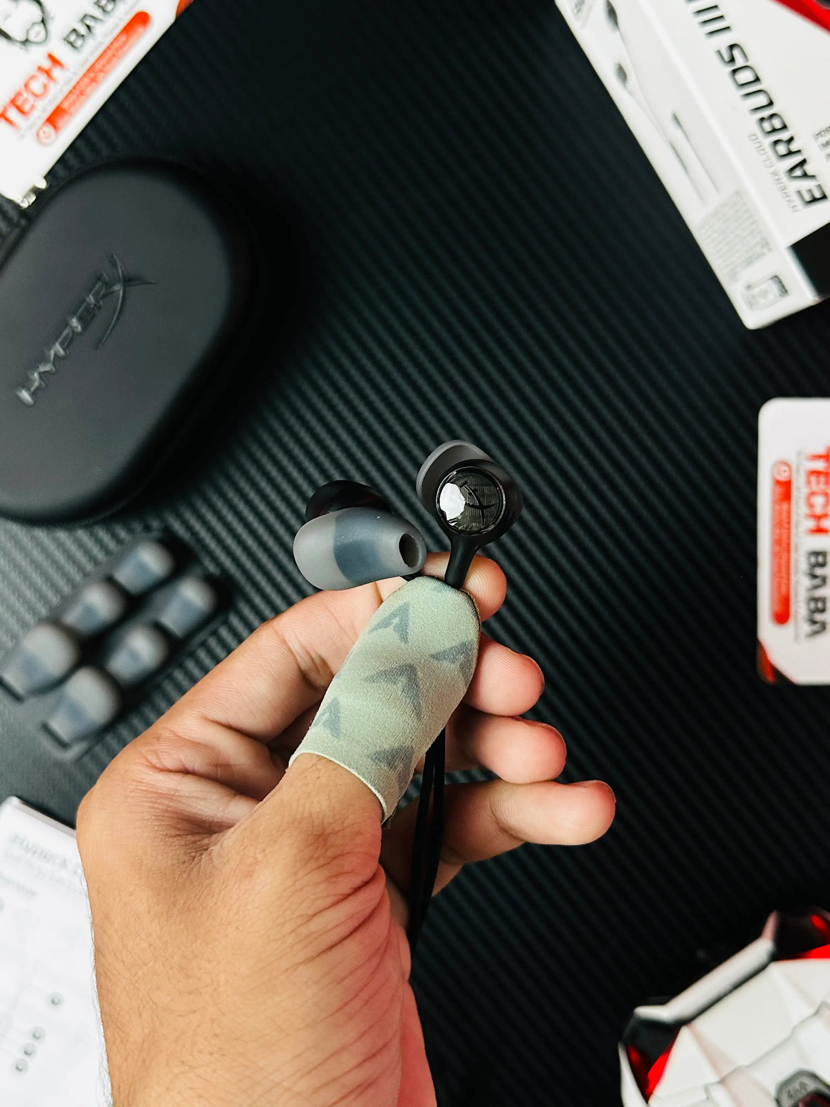 A hand holding earbuds of HyperX Cloud Earbuds III S USB-C Gaming Earbuds-p[icture by TEchbabastore.pk