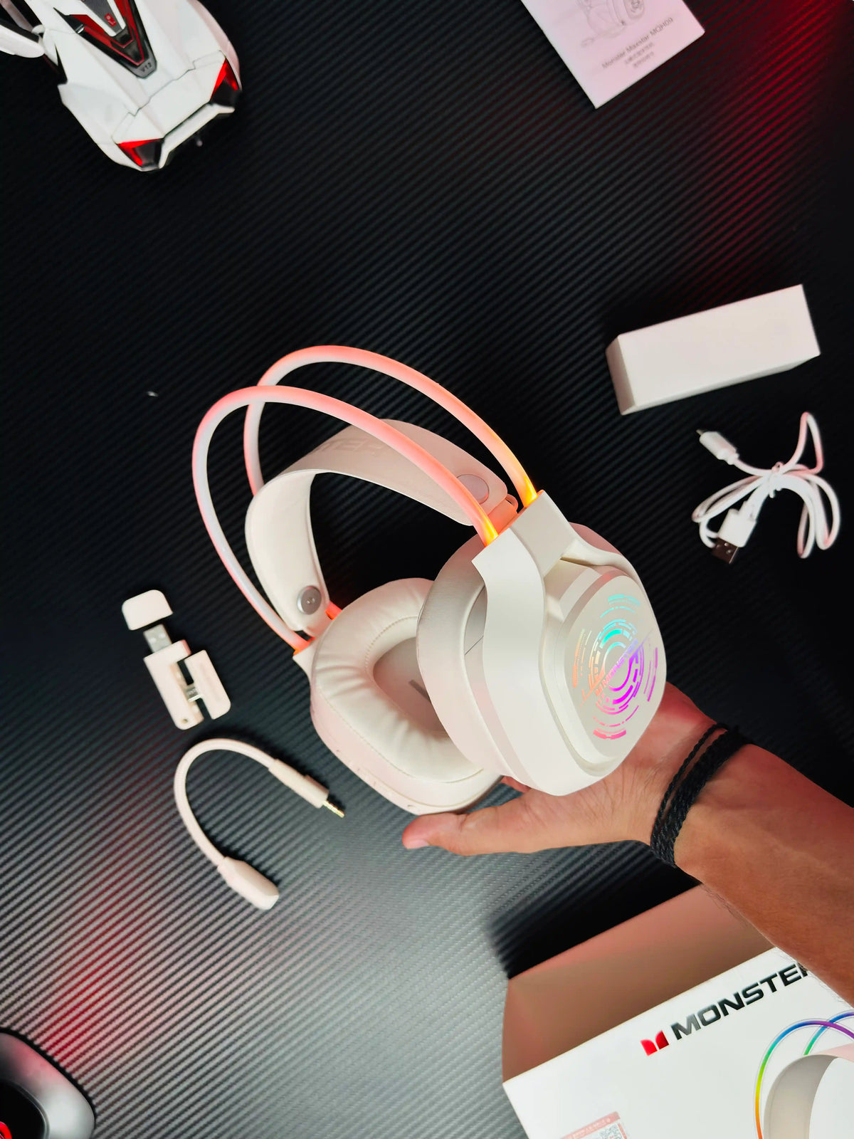 A hand hlding Monster_Maxstar_MQH09_Wireless_Gaming_Headphone_50mm_Driver_Bluetooth_5.4_IPX5_Best_PUBG_Headset_Pakistan_TechBabaStore.pk which has showing all things. picture by TechBabaStore.pk