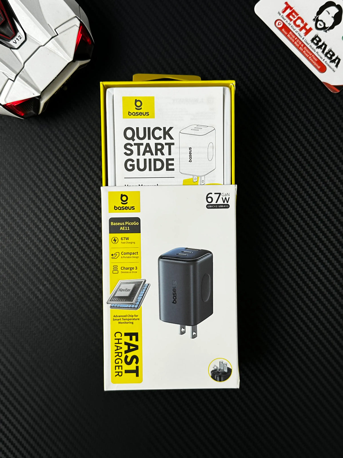 showing half open box of Tittle image of Baseus PicoGo AE11 67W GaN Fast Charger 2C+U — Dual USB-C + USB-A, PD3.0/QC4.0/PPS. picture by Techbabastore.pk