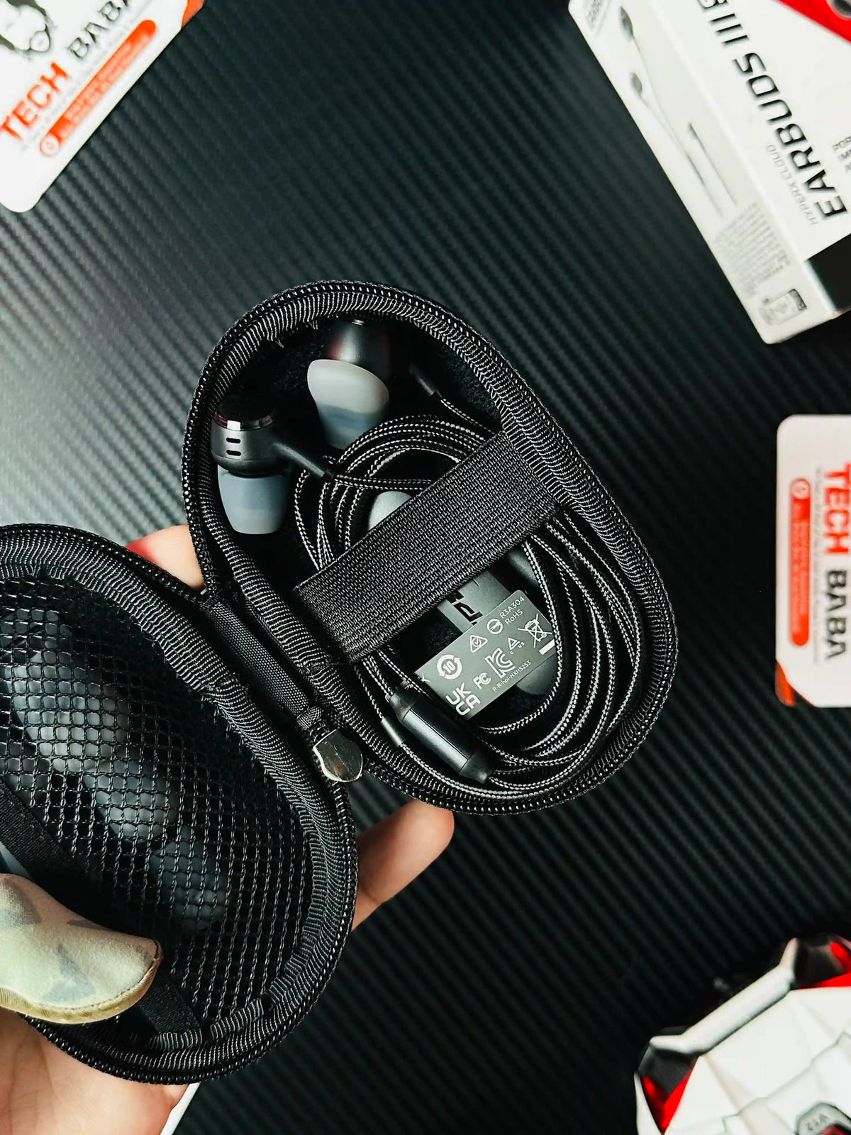 A hand holidng hqalf open pouch of HyperX Cloud Earbuds III S USB-C Gaming Earbuds which has showing earbuds -picture by Techbabastore.pk
