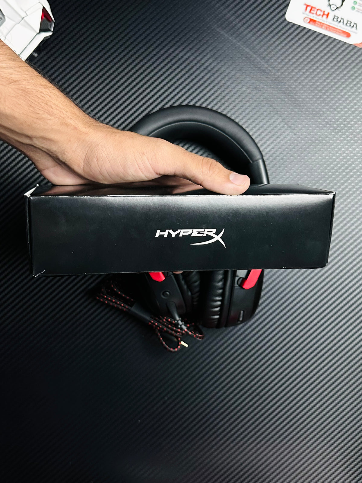 A hand holding HyperX Cloud III Gaming Headset for PUBG Mobile  which has showing hyper box.picture by TechBabaStore.pk