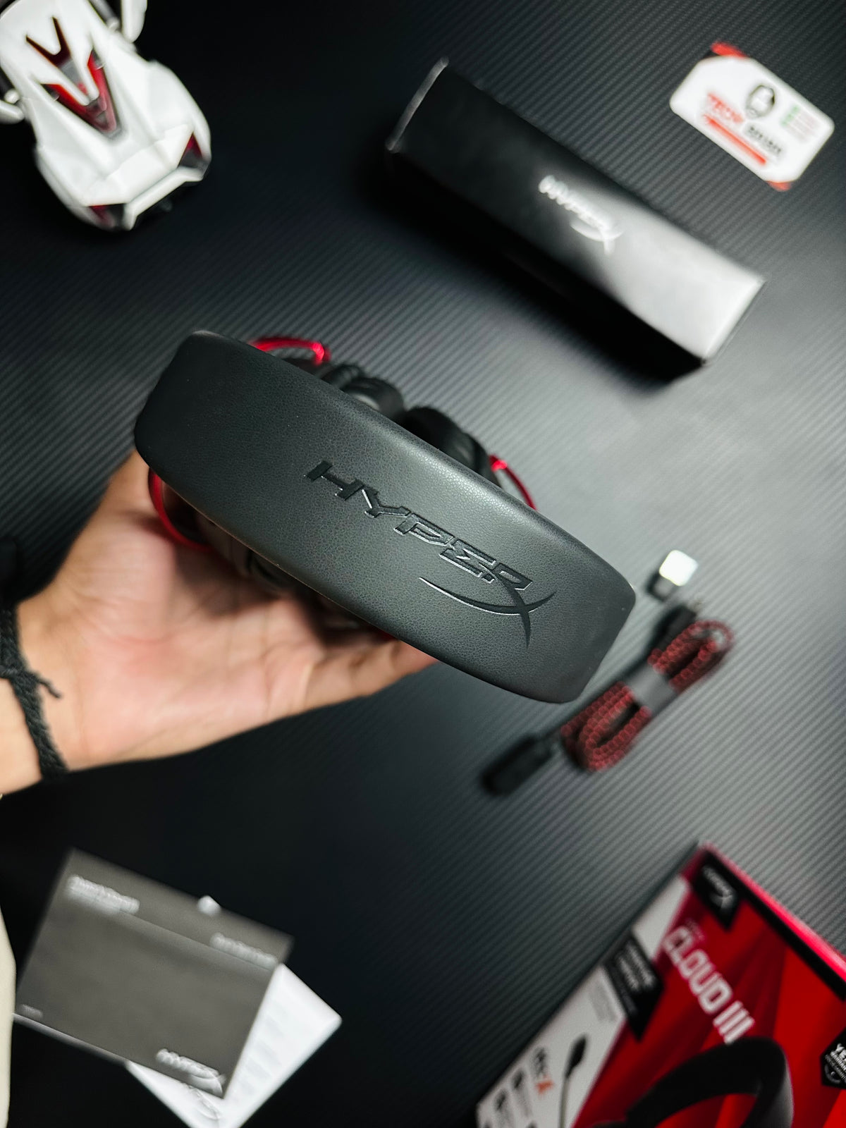 A hand holding HyperX Cloud III Gaming Headset for PUBG Mobile  which has showing hyper label.picture by TechBAbaStore.pk