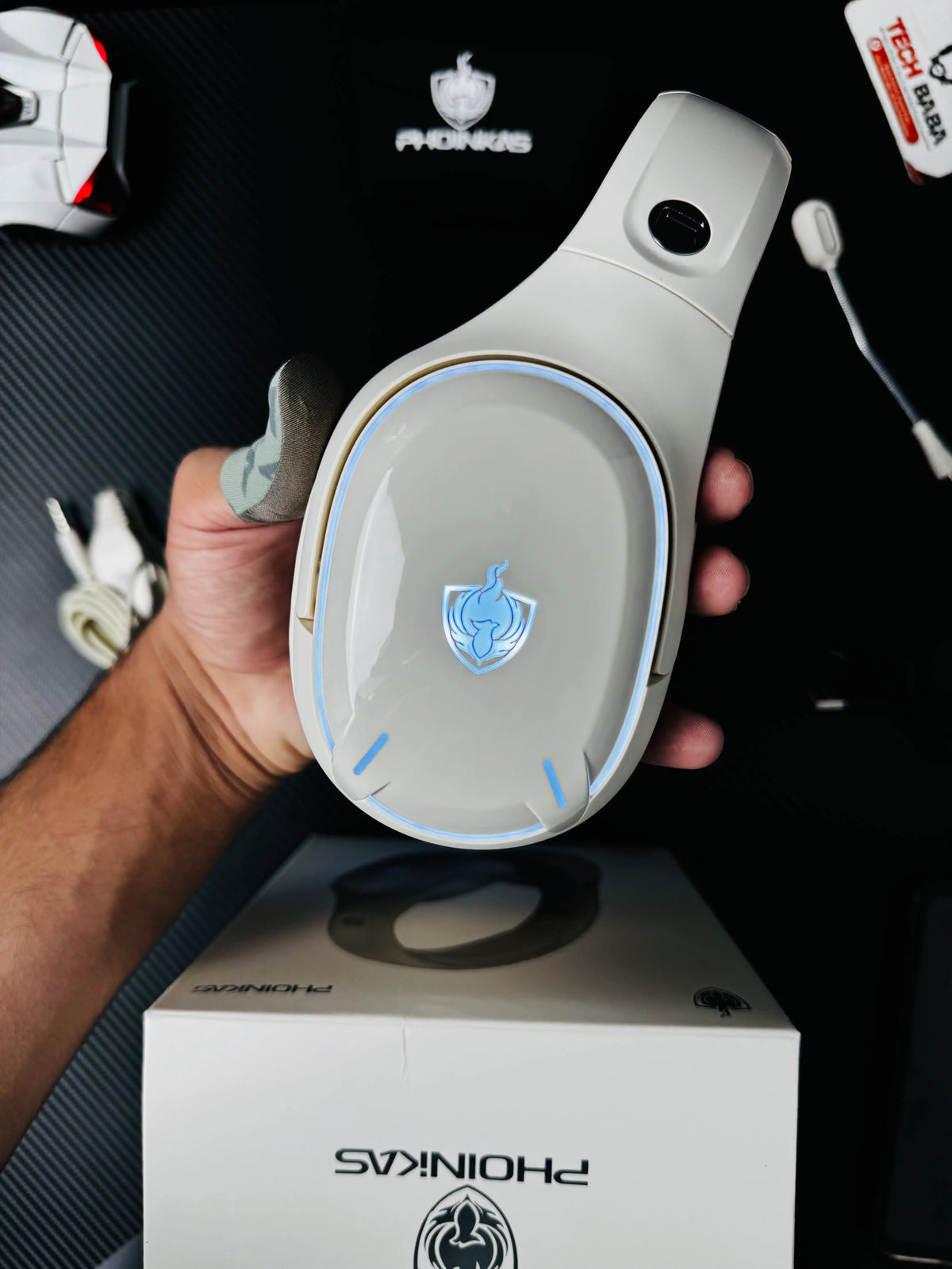 A hand holding Phoinikas Q6S Wireless Gaming Headset — Bluetooth 5.3, Detachable Mic, 30Hrs Battery | Best PUBG Headset Pakistan which has showing left side.picture by TechBabaStore.pk