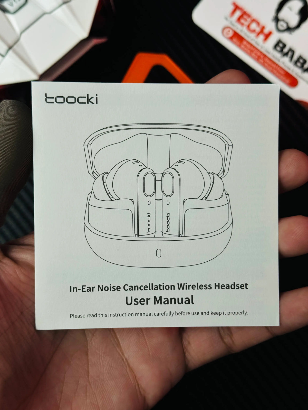 A hand holding Tocki Zero Delay Gaming Earbuds monugram_picture by TechBabaStore.pk