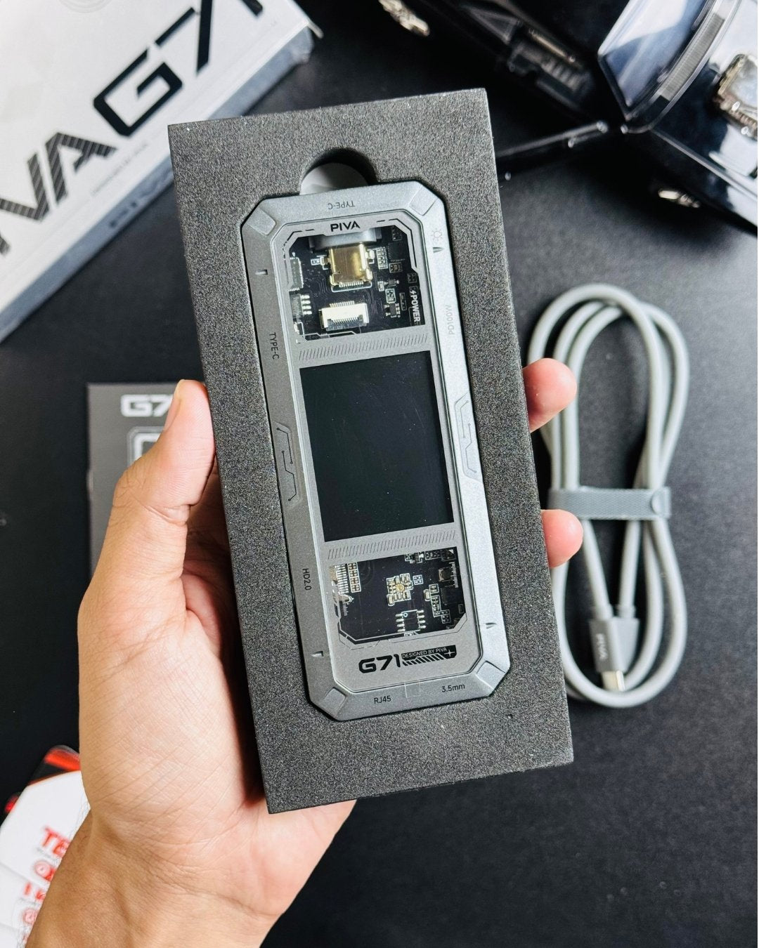 a hand hoding open PIVA_G71_7-in-1_Gaming_Splitter_Docking_Station picture by Techbabastore.pk