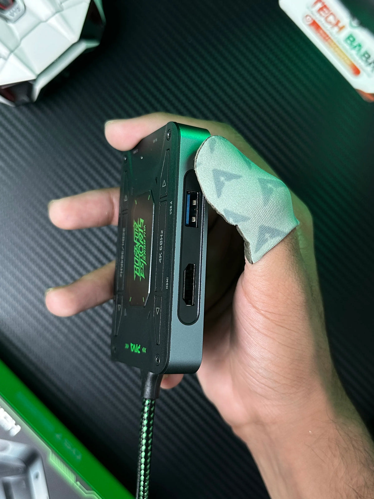 A hand holding Piva DS7 7-in-1 Gaming Splitter — Ethernet, 100W PD, 4K HDMI for PUBG Mobile which has showing its side ports, including a USB-A 3.1 port and an HDMI port. picture by TEchBAbaStore.pk