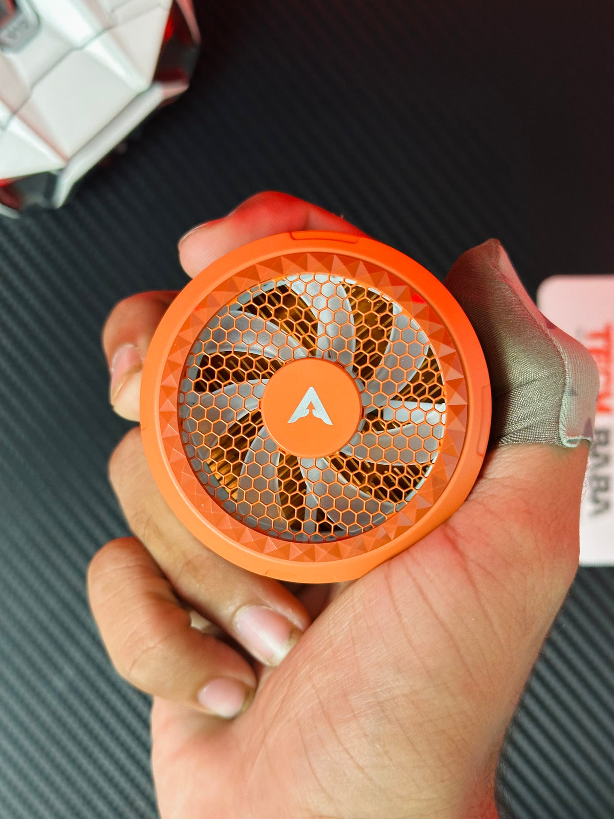 a hand holding orange piva X30. picture by TechBabastore