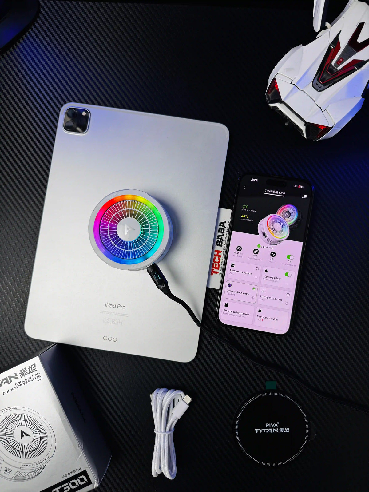 showing Piva Titan T300 iPad Cooler — 45W Semiconductor Cooling Fan for PUBG Mobile attached on ipad and running full power wired connected with piva mubile app and also showing all box compoonent of piva titan t300.picture by TechBabaStore.pk