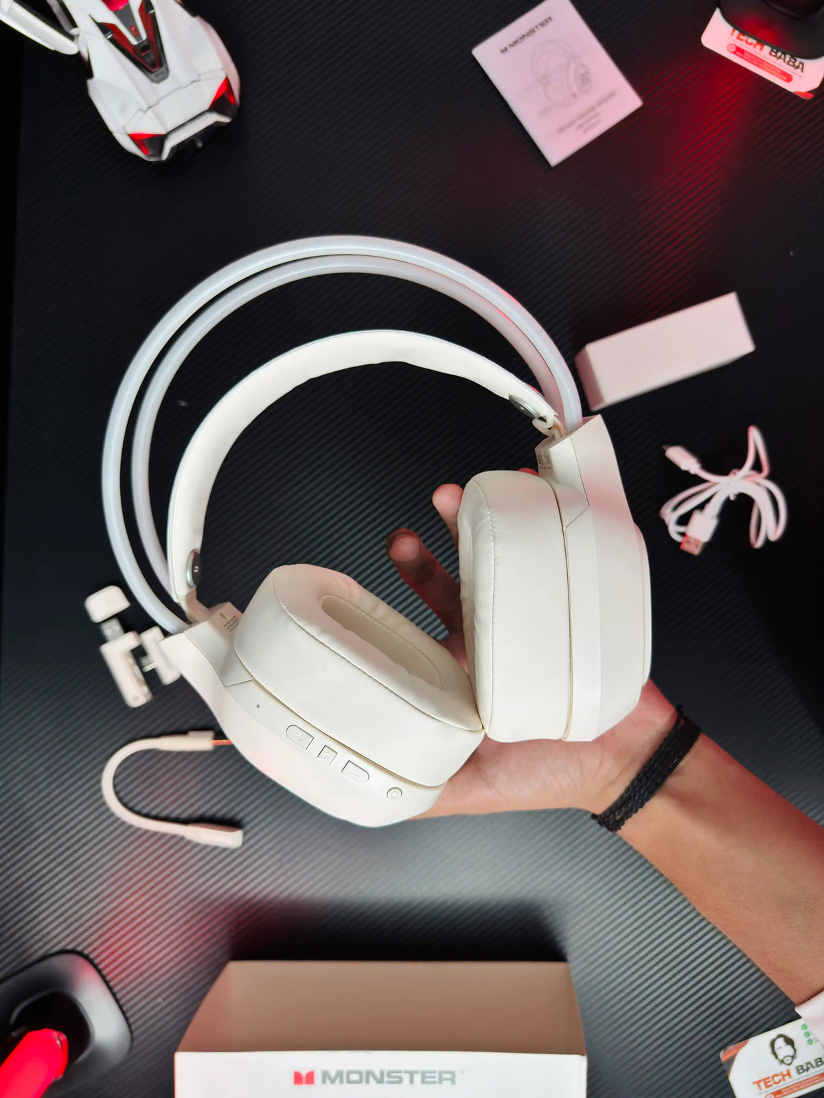A hand holding Monster_Maxstar_MQH09_Wireless_Gaming_Headphone_50mm_Driver_Bluetooth_5.4_IPX5_Best_PUBG_Headset_Pakistan_which has showing left side.picture by TechBabaStore.pk