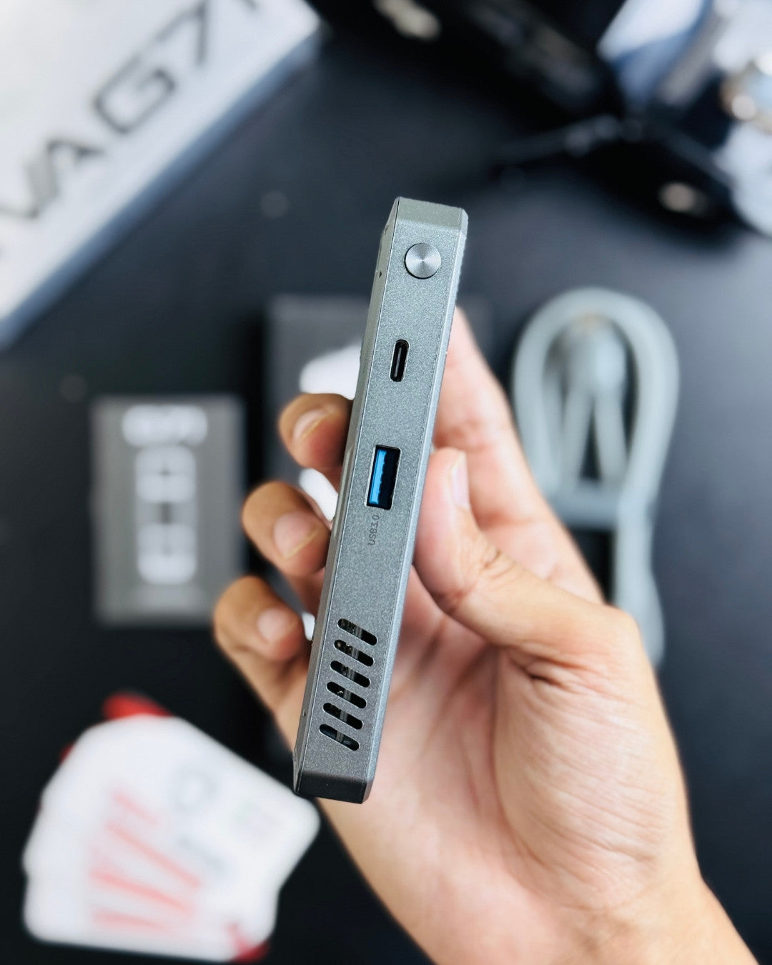 a hand holding PIVA_G71_7-in-1_Gaming_Splitter_Docking_Station which has showing type D and type C port picture by techbabastore.pk