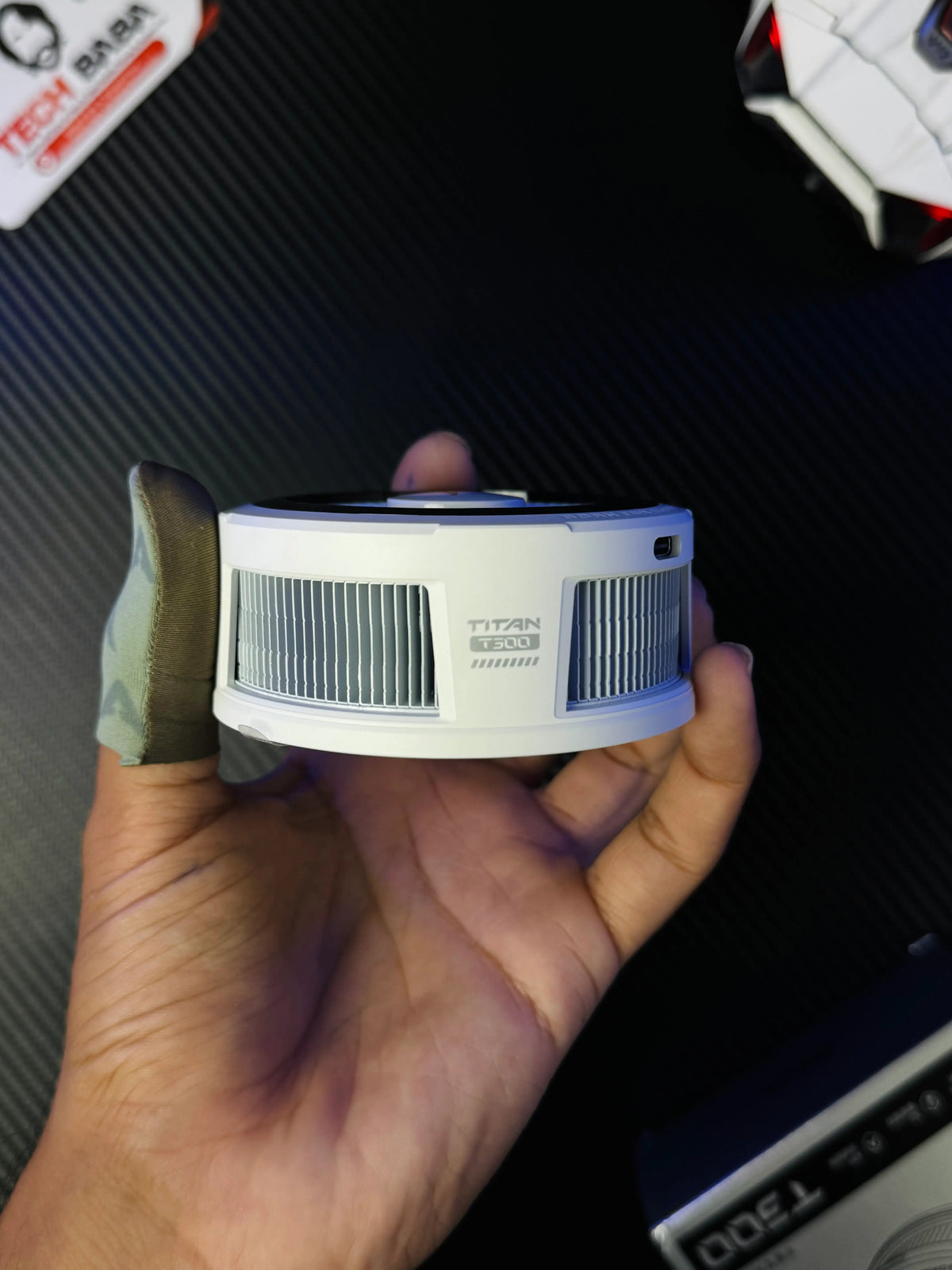 A hand holding Piva Titan T300 iPad Cooler — 45W Semiconductor Cooling Fan for PUBG Mobile which has showing sides.picture by TechBabaStore.pk