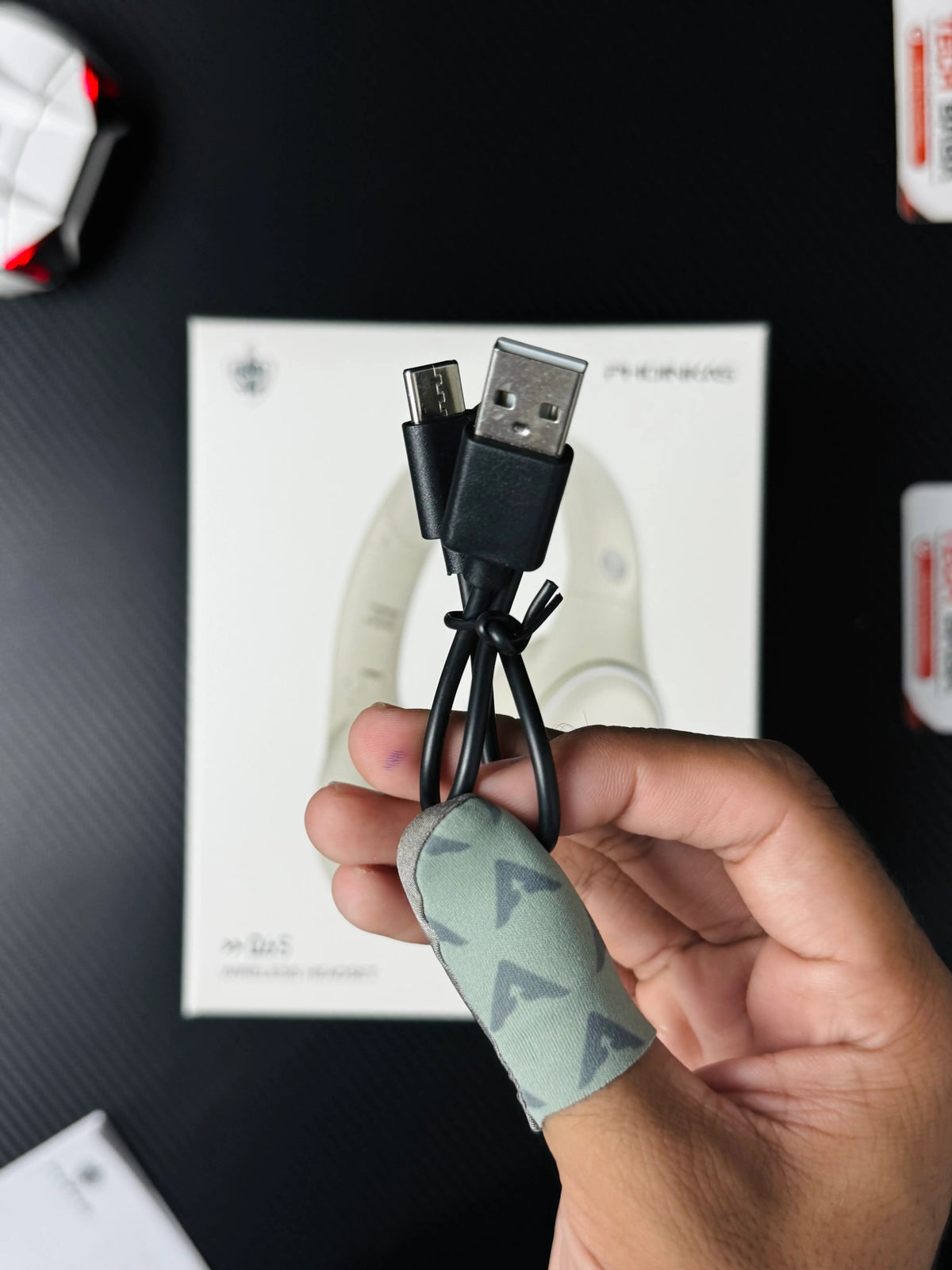 A hand holding Phoinikas Q6S Wireless Gaming Headset — Bluetooth 5.3, Detachable Mic, 30Hrs Battery | Best PUBG Headset Pakistan TypeC wire. picture by TechBabaStore .pk