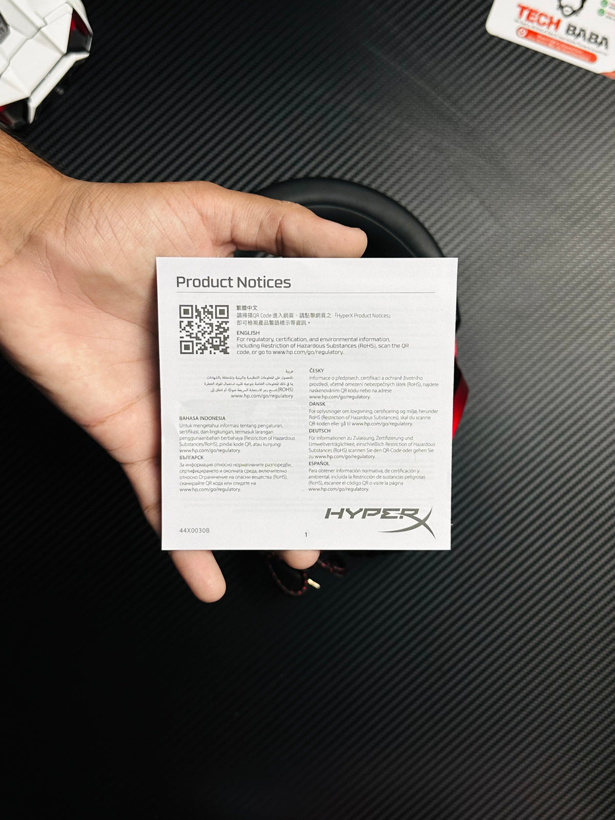 A hand holding HyperX Cloud III Gaming Headset for PUBG Mobile which has showing usermanual.picture by TechBabaStore.pk