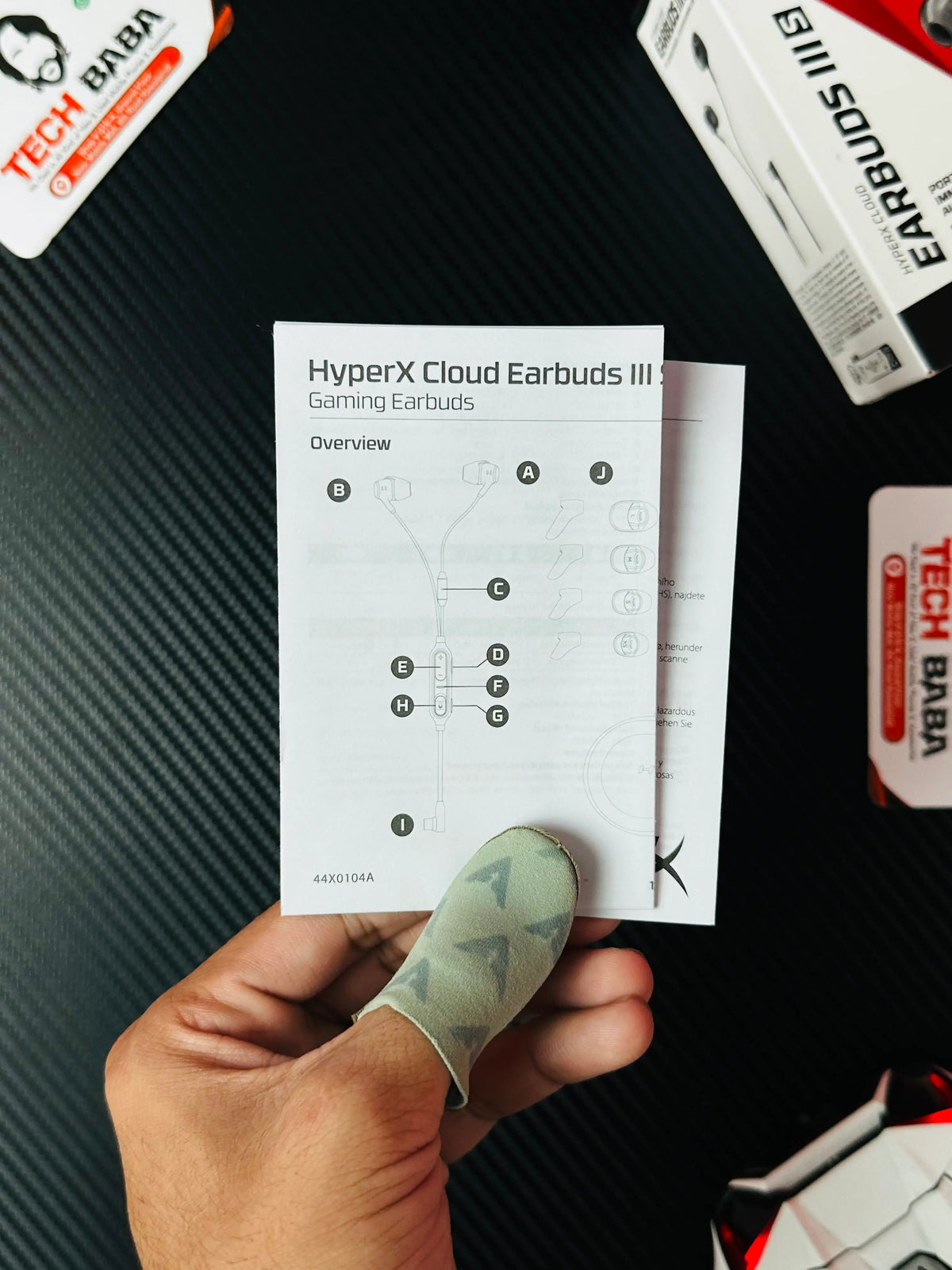 A hand holding user manual of HyperX Cloud Earbuds III S USB-C Gaming Earbuds-picture by TechBAbaStore.pk